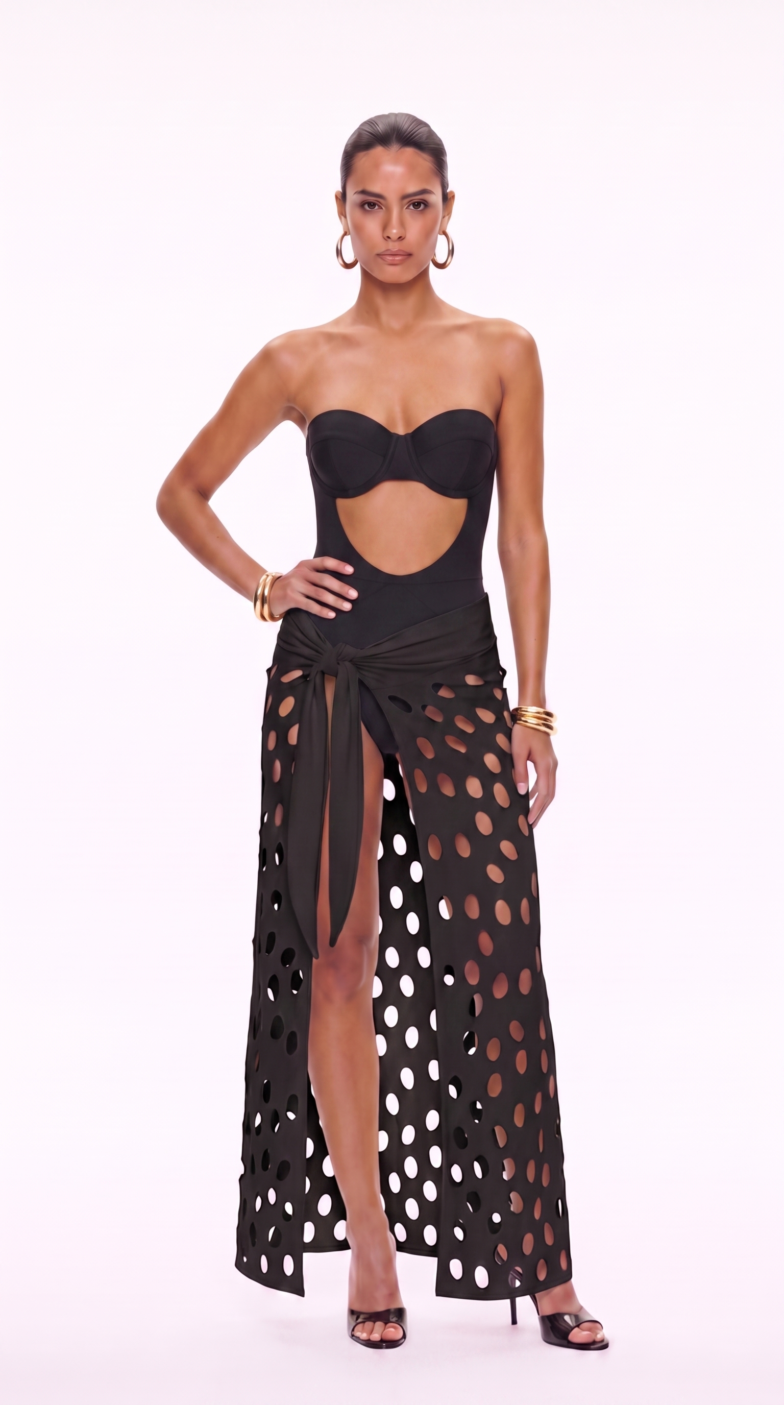 Black cutwork maxi skirt with high waist tie and oval holes paired with bodysuit